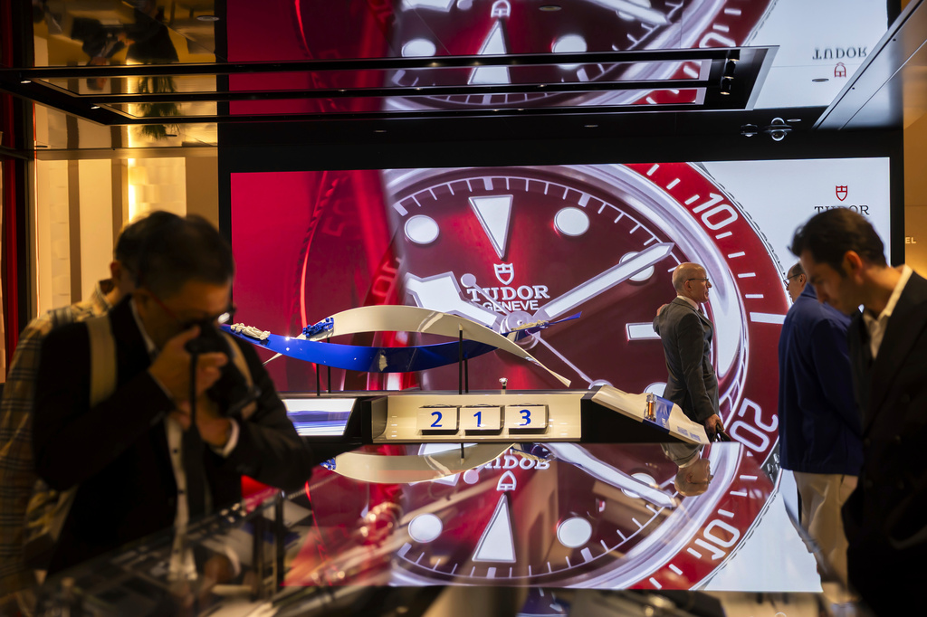 FILE - Visitors gather at the Swiss manufacture TUDOR stand during the "Watches and Wonders Geneva" luxury watch fair, in Geneva, Switzerland, Wednesday, April 2, 2025. (Salvatore Di Nolfi/Keystone via AP, File)