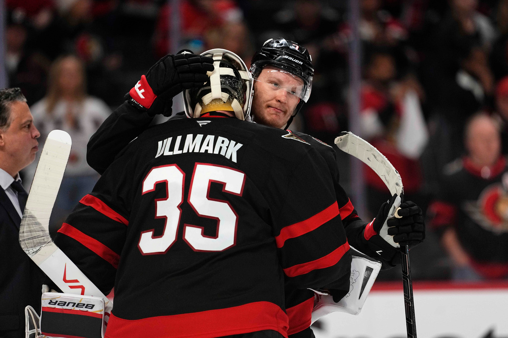 Ottawa Senators' Brady Tkachuk (7) embraces goaltender Linus Ullmark (35) after their team was eliminated by the Carolina Hurricanes after losing in Game 4 of a first-round NHL Stanley Cup playoff hockey series, Saturday, April 25, 2026, in Ottawa, Ontario. (Justin Tang/The Canadian Press via AP)