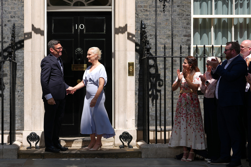 Britain's new Prime Minister Andy Burnham and his wife Marie-France van Heel arrive at 10 Downing Street in London, Monday, July 20, 2026.(AP Photo/Kirsty Wigglesworth)