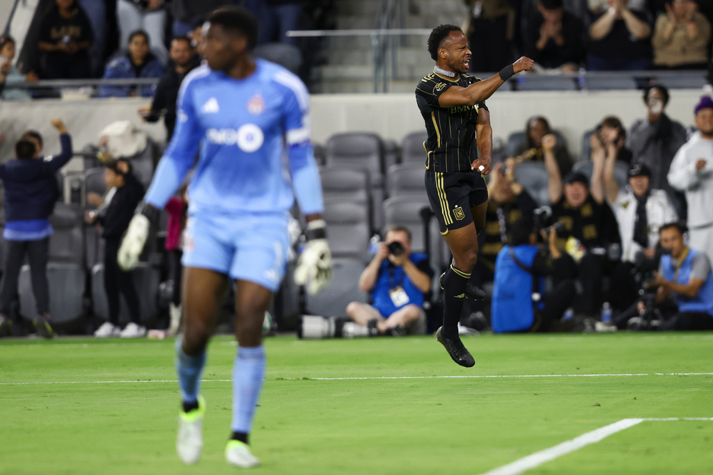 Los Angeles FC forward Jeremy Ebobisse celebrates after scoring a goal as Toronto FC goalkeeper Sean Johnson, left, looks on during the first half of an MLS soccer match, Wednesday, Oct. 8, 2025, in Los Angeles. (AP Photo/Jessie Alcheh)