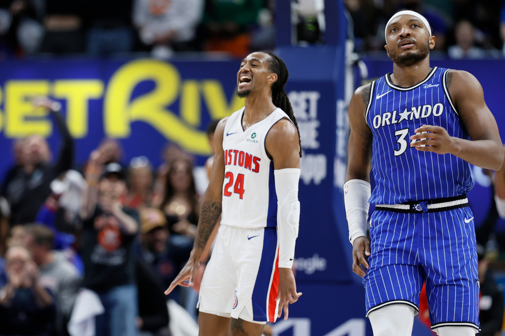 Detroit Pistons guard Daniss Jenkins (24) celebrates after sinking a three-point basket as Orlando Magic center Wendell Carter Jr., right, walks away during the fourth quarter in Game 7 of a first-round NBA basketball playoffs series Sunday, May 3, 2026, in Detroit. (AP Photo/Duane Burleson)
