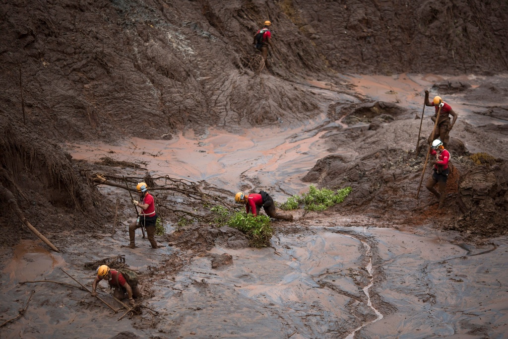 FILE - Rescue workers search for victims after a dam burst in the town of Bento Rodrigues in Minas Gerais state, Brazil, Nov. 8, 2015. (AP Photo/Felipe Dana, File)