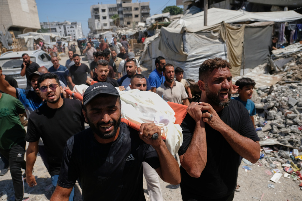 Palestinians carry the body of Abdullah Hamouda, 14, who, according to health authorities, was killed in an Israeli military strike, during his funeral in Gaza City, Tuesday, Sept. 1, 2026. (AP Photo/Jehad Alshrafi)