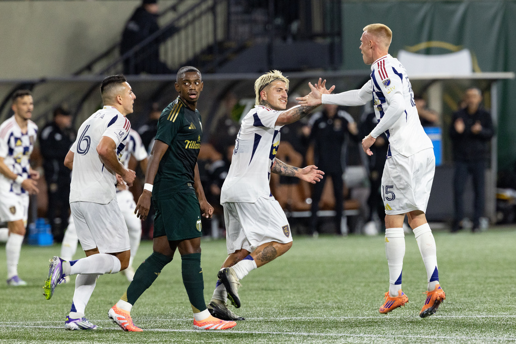 Real Salt Lake defender Justen Glad, right, celebrates his goal against the Portland Timbers during the first half of an MLS soccer match Wednesday, Oct. 22, 2025, in Portland, Ore. (AP Photo/Howard Lao)