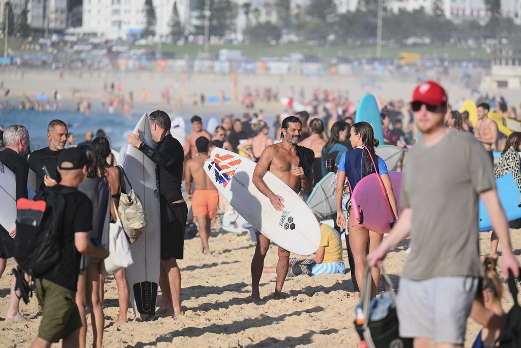 FILE - Surfers and swimmers leave the water after a tribute following last Sunday's shooting at Bondi Beach, in Sydney, Friday, Dec. 19, 2025. (AP Photo/Steve Markham,File)