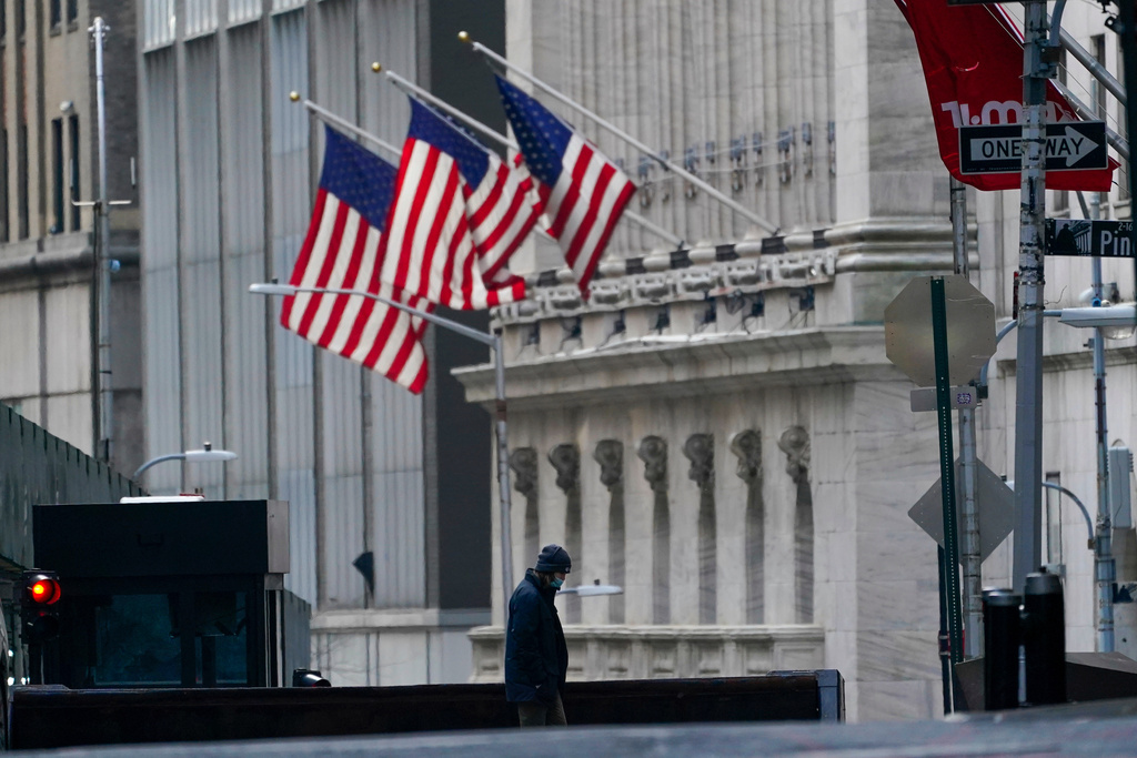 FILE - A security guard is seen next to a road block near the New York Stock exchange, Jan. 14, 2022, in the Financial District. (AP Photo/Mary Altaffer, File)