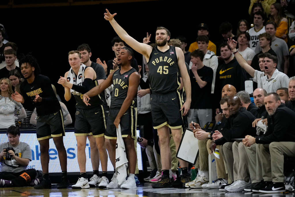 Purdue center Oscar Cluff (45) celebrates on the bench during the first half of an NCAA college basketball game against Iowa, Saturday, Feb. 14, 2026, in Iowa City, Iowa. (AP Photo/Charlie Neibergall)