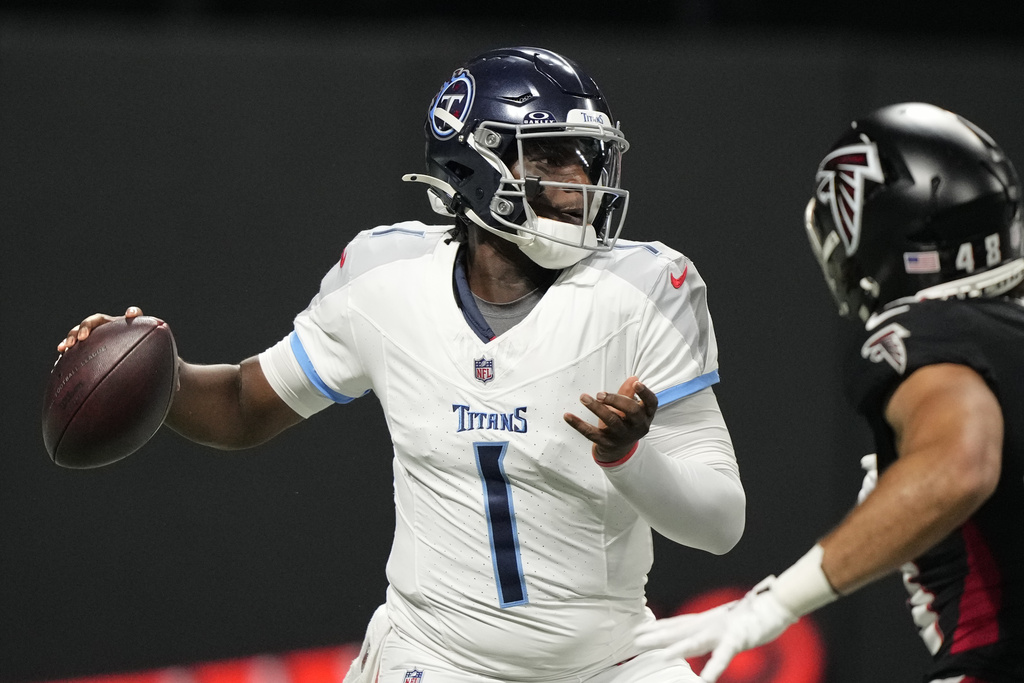 Tennessee Titans quarterback Cam Ward (1) looks to throw a pass during the first half of a preseason NFL football game against the Atlanta Falcons, Friday, Aug. 15, 2025, in Atlanta. (AP Photo/Brynn Anderson)