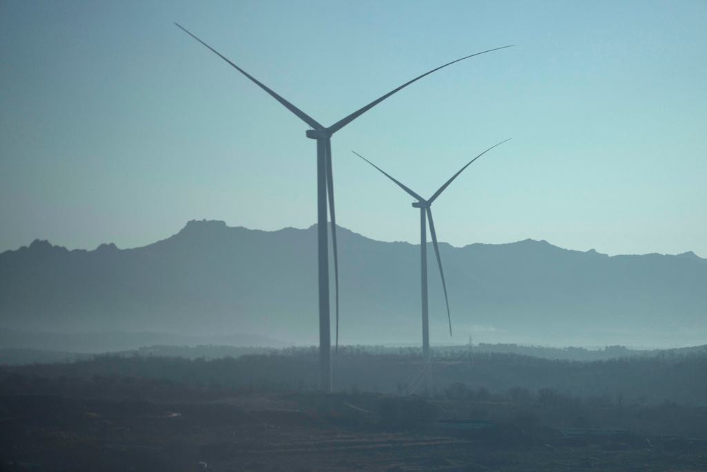 CORRECTS THE LOCATION OF THE AREA TO NORTHEASTERN, NOT NORTHWESTERN - Wind turbines are seen in China's northeastern region, as seen from a train from Beijing to Shenyang on Jan. 3, 2026. (AP Photo/Ng Han Guan)