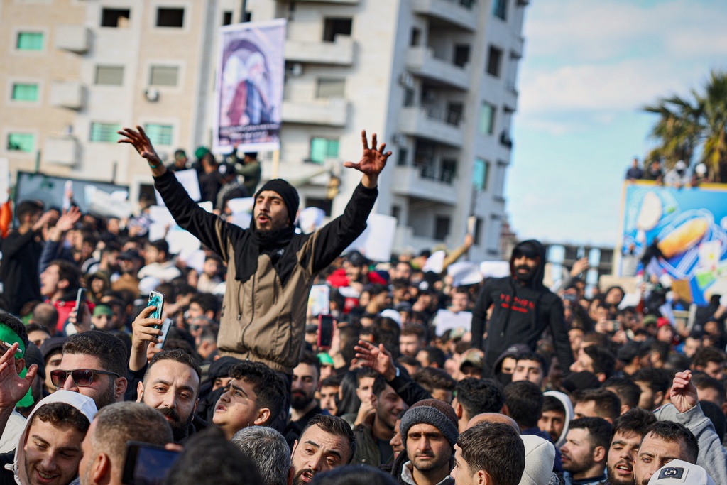 Protesters from the Alawite religious minority demonstrate two days after a bomb in an Alawite mosque in Homs killed eight people and wounded 18 during Friday prayers, in Latakia, Syria's coastal region, Sunday, Dec. 28, 2025. (AP Photo/Omar Albam)