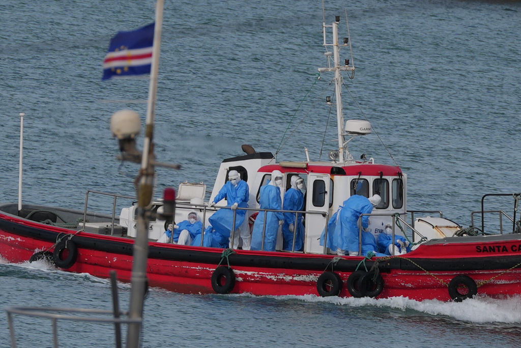 Health workers in protective gear arrive to evacuate patients from the MV Hondius cruise ship at a port in Praia, Cape Verde, Wednesday, May 6, 2026. (AP Photo/Misper Apawu)