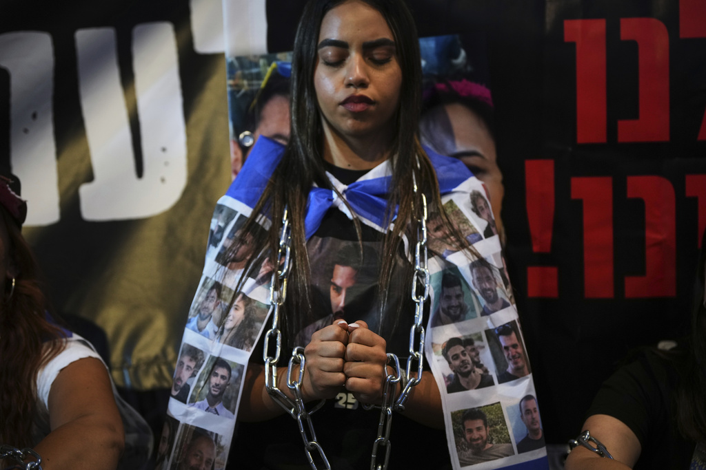 Relatives and supporters of Israeli hostages held in the Gaza Strip attend a rally demanding their release from Hamas captivity and calling for an end to the war outside the prime minister's office in Jerusalem, Thursday, Aug. 7, 2025. (AP Photo/Ohad Zwigenberg)