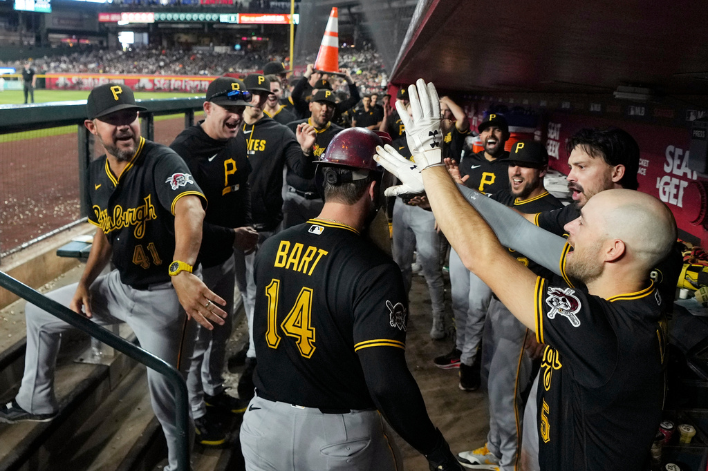 Pittsburgh Pirates' Joey Bart (14) celebrates his home run against the Arizona Diamondbacks with Pirates bench coach Kristopher Negrón (41) and Pirates' Brandon Lowe (5)during the sixth inning of a baseball game, Thursday, May 7, 2026, in Phoenix. (AP Photo/Ross D. Franklin)