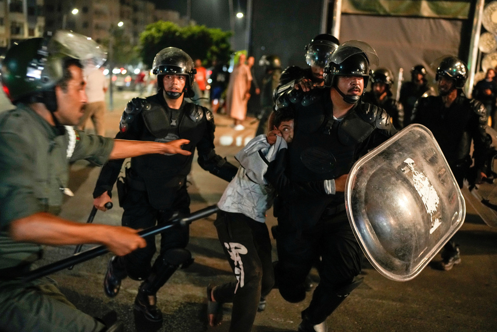 A boy is detained as youth led protests calling for healthcare and education reforms turned violent, in Sale, Morocco, Wednesday, Oct. 1, 2025. (AP Photo/Mosa'ab Elshamy)