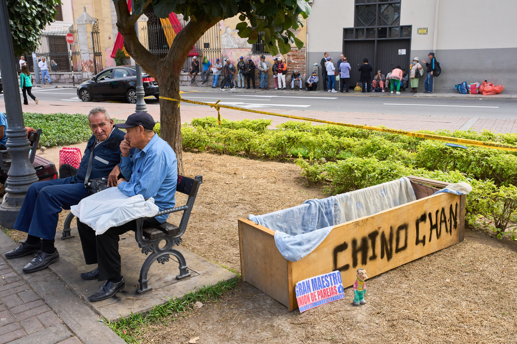 Men sit at a park in Lima, Peru, Monday, June 8, 2026, the day after the presidential election runoff. (AP Photo/Rodrigo Abd)