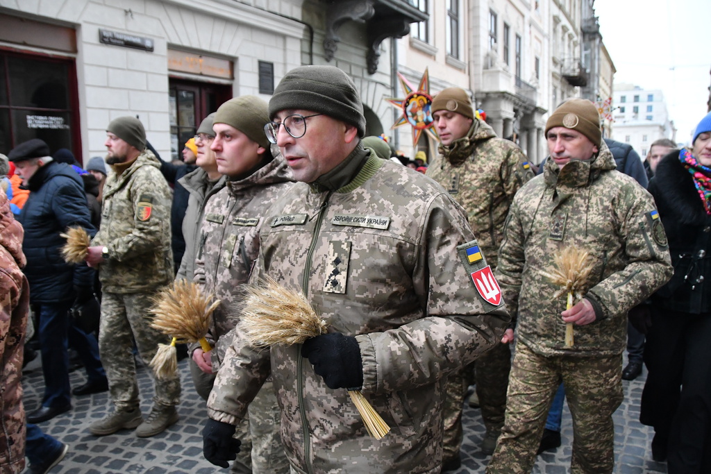 Ukrainian servicemen attend a parade on Orthodox Christmas eve in downtown Lviv, Ukraine, on Wednesday, Dec. 24, 2025. (AP Photo/Mykola Tys)