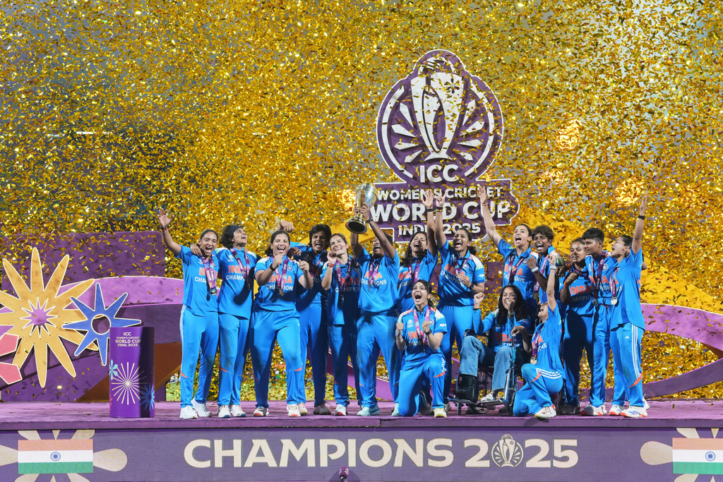 Indian players celebrate with the trophy after their win over South Africa in the ICC Women's Cricket World Cup final match in Navi Mumbai, India, Sunday, Nov. 2, 2025. (AP Photo/Rafiq Maqbool)