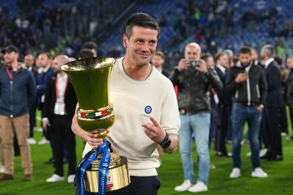 Inter Milan head coach Cristian Chivu poses with the trophy after defeating Lazio to win the Italian Cup soccer final in Rome, Wednesday, May 13, 2026. (AP Photo/Andrew Medichini)