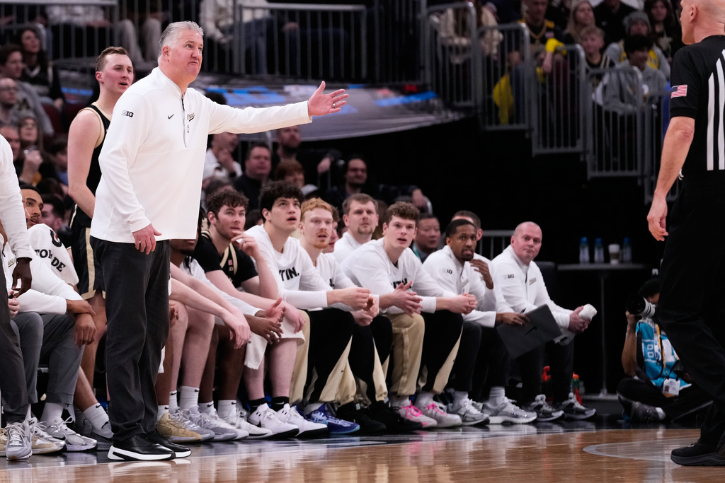 Purdue head coach Matt Painter, front left, reacts to a call during the first half of an NCAA college basketball game against Michigan in the championship of the Big 10 Conference tournament, Sunday, March 15, 2026, in Chicago. (AP Photo/Nam Y. Huh)
