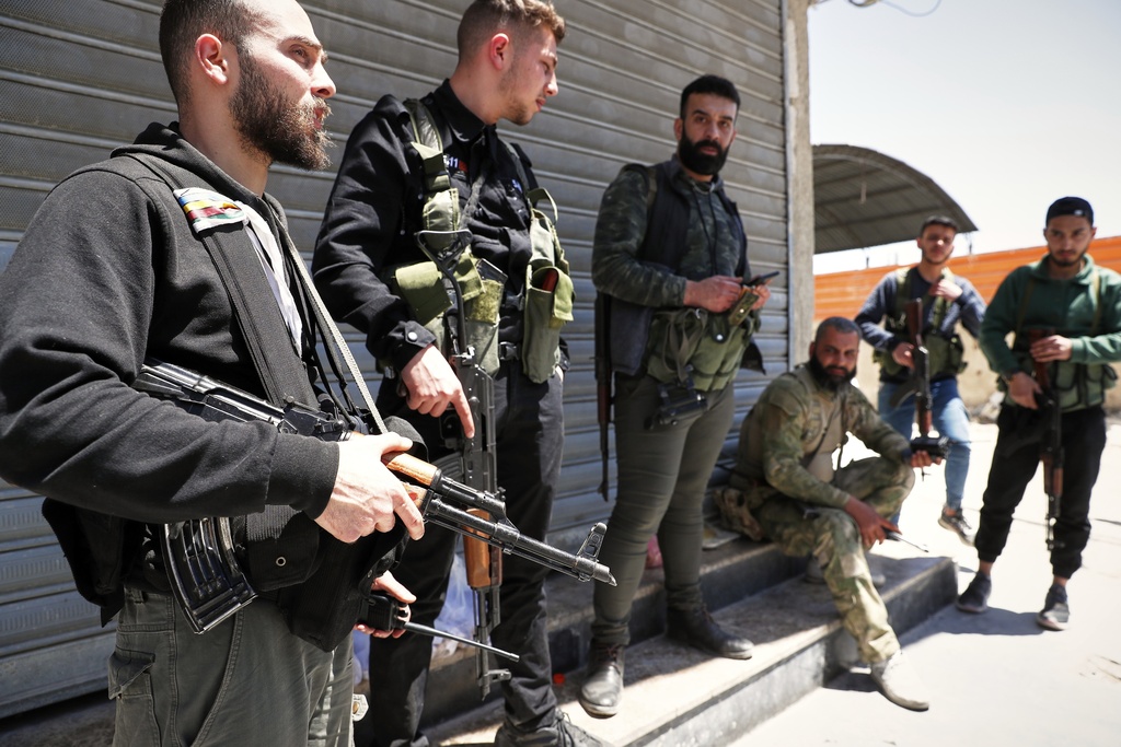 Druze gunmen stand next to a checkpoint a day after clashes between members of the minority Druze sect and pro-government fighters left at least four people dead in the southern suburb of Jaramana, Damascus, Syria, Tuesday, April 29, 2025. (AP Photo/Omar Sanadiki)