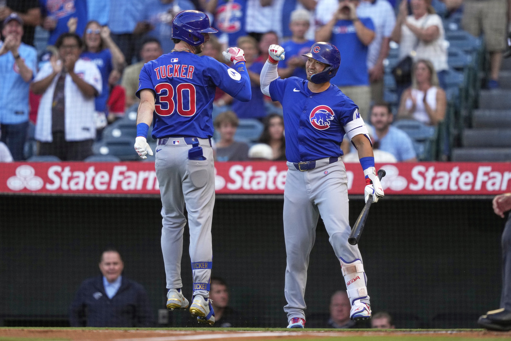 Chicago Cubs' Kyle Tucker is congratulated by Seiya Suzuki after hitting a solo home run during the first inning of a baseball game Friday, Aug. 22, 2025, in Anaheim, Calif. (AP Photo/Mark J. Terrill)