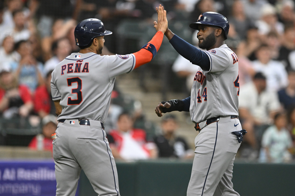 Houston Astros' Yordan Alvarez (44) celebrates with teammate Jeremy Pena (3) after scoring on a Isaac Paredes three-run single during the sixth inning of a baseball game against the Chicago White Sox in Chicago, Saturday, July 25, 2026. (AP Photo/Paul Beaty)