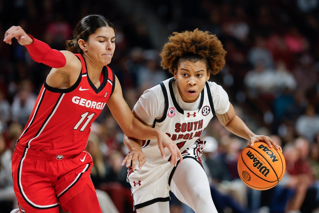 South Carolina guard Maddy McDaniel, right, moves the ball against Georgia guard Enjulina Gonzalez during the first half of an NCAA college basketball game in Columbia, S.C., Sunday, Jan. 11, 2026. (AP Photo/Nell Redmond)