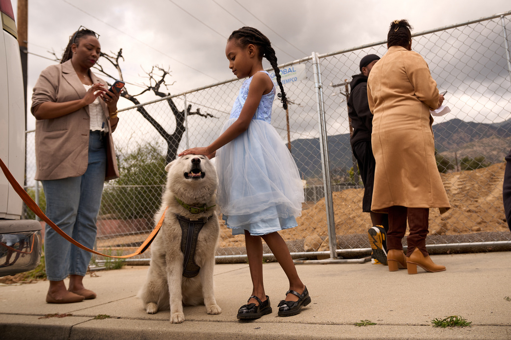 Members of the congregation attend a groundbreaking service at the site of the burned Fountain of Life Nazarene Church, marking the beginning of its rebuilding, in Altadena, Calif., April 26, 2026. (AP Photo/Damian Dovarganes)