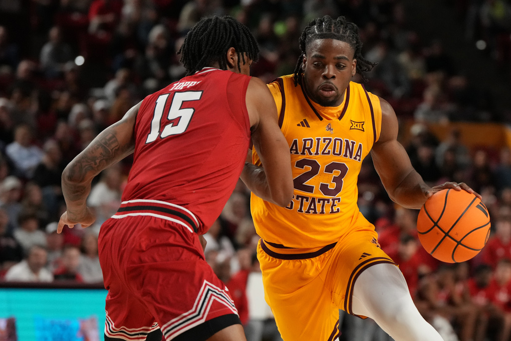Arizona State forward Allen Mukeba (23) drives on Texas Tech forward JT Toppin during the second half of an NCAA college basketball game, Tuesday, Feb. 17, 2026, in Tempe, Ariz. (AP Photo/Rick Scuteri)
