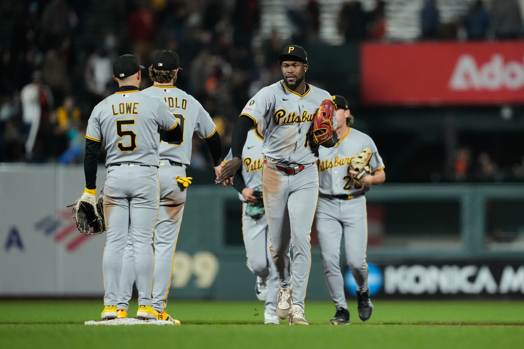 Pittsburgh Pirates center fielder Oneil Cruz (15) celebrates with shortstop Jared Triolo, second from left, after the team's victory over the San Francisco Giants in a baseball game Saturday, May 9, 2026, in San Francisco. (AP Photo/Godofredo A. Vásquez)