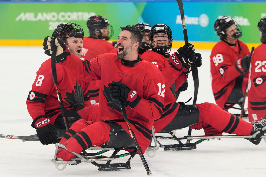 Canada players celebrate after winning a semifinal hockey match between against China at the 2026 Winter Paralympics, in Milan, Italy, Friday, March 13, 2026. (AP Photo/Luca Bruno)