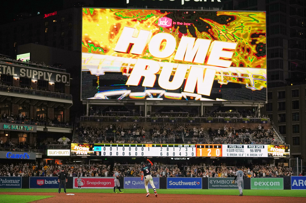 San Diego Padres' Jackson Merrill, center, celebrates after hitting a home run during the eighth inning of a baseball game against the Miami Marlins Friday, Sept. 18, 2026, in San Diego. (AP Photo/Gregory Bull)