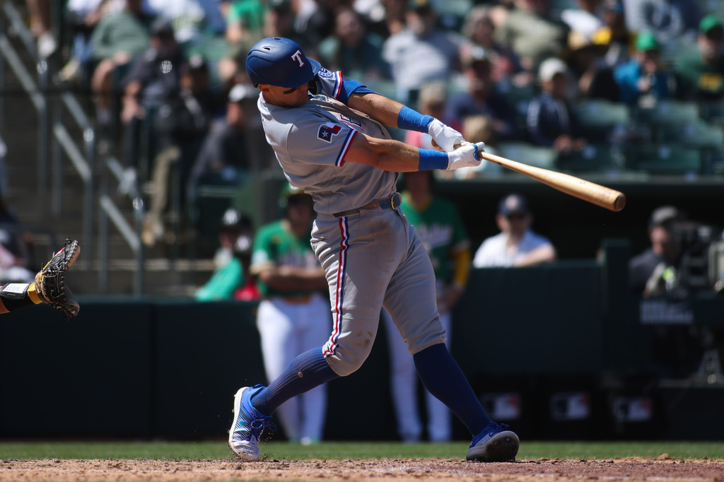 Texas Rangers' Josh Jung hits a two-run home run during the seventh inning of a baseball game against the Athletics, Thursday, April 16, 2026, in West Sacramento, Calif. (AP Photo/Scott Marshall)