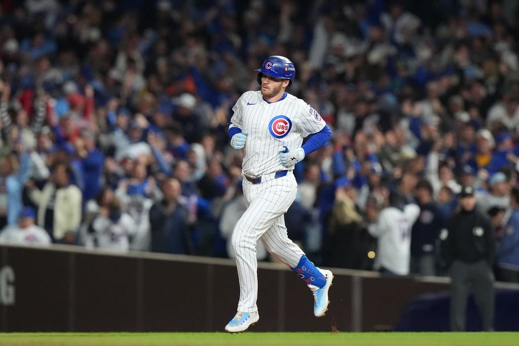 Chicago Cubs' Ian Happ (8) runs the bases after hitting a 3-run home run during the first inning of Game 4 of baseball's National League Division Series against the Milwaukee Brewers Thursday, Oct. 9, 2025, in Chicago. (AP Photo/Nam Y. Huh)