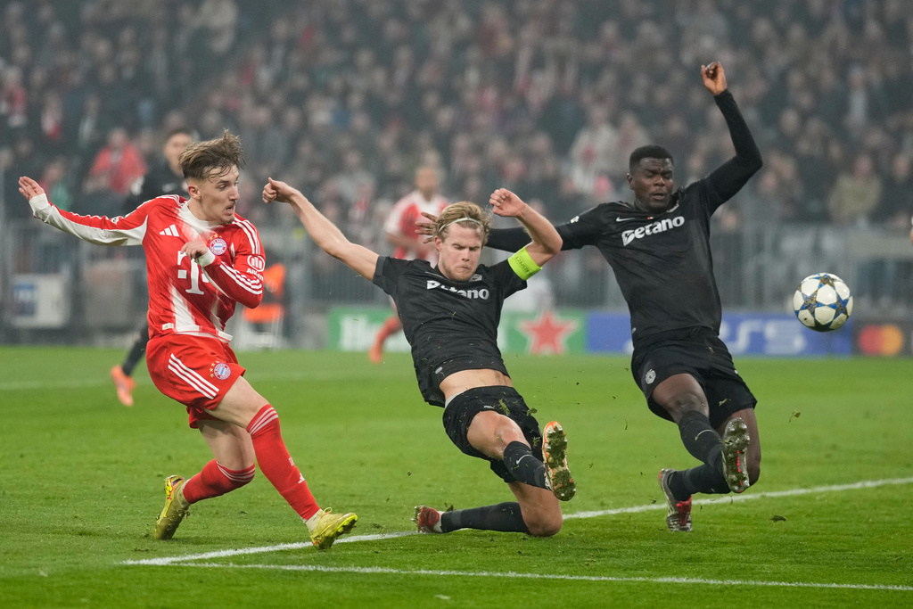 Bayern's Lennart Karl, left, scores his side's second goal during the Champions League opening phase soccer match between FC Bayern Munich and Sporting CP in Munich, Germany, Tuesday, Dec. 9, 2025. (AP Photo/Matthias Schrader)