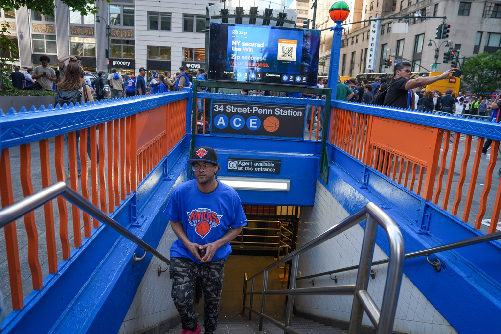 A New York Knicks fan emerges from a subway station outside of Madison Square Garden ahead of Game 3 of the NBA Finals, Monday, June 8, 2026, in New York. (AP Photo/Ryan Murphy)