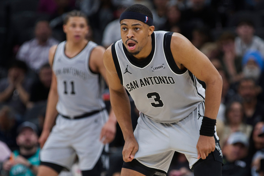San Antonio Spurs forward Keldon Johnson (3) watches play during the second half of an NBA basketball game against the Portland Trail Blazers, Wednesday, April 8, 2026, in San Antonio. (AP Photo/Darren Abate)