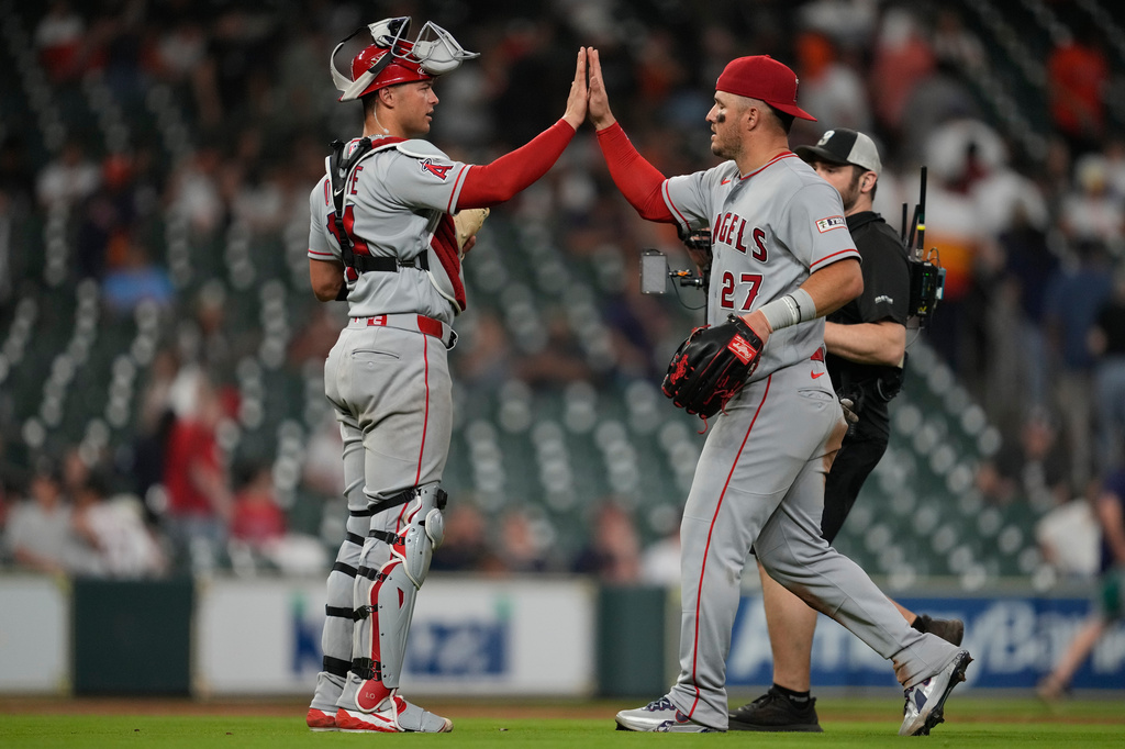 Los Angeles Angels catcher Logan O'Hoppe (14) celebrates with center fielder Mike Trout (27) after winning a baseball game against the Houston Astros in Houston, Friday, March 27, 2026. (AP Photo/Ashley Landis)