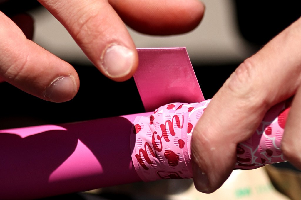 Mothers day-themed bat tape is applied to a Chicago White Sox baseball bat before a game against against the Seattle Mariners at Rate Field on Sunday, May 10, 2026, in Chicago, Ill. (AP Photo/Geoff Stellfox)