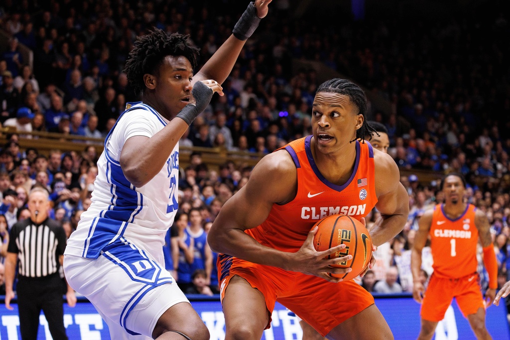 Clemson's RJ Godfrey, right, handles the ball as Duke's Patrick Ngongba II, left, defends during the first half of an NCAA college basketball game in Durham, N.C., Saturday, Feb. 14, 2026. (AP Photo/Ben McKeown)
