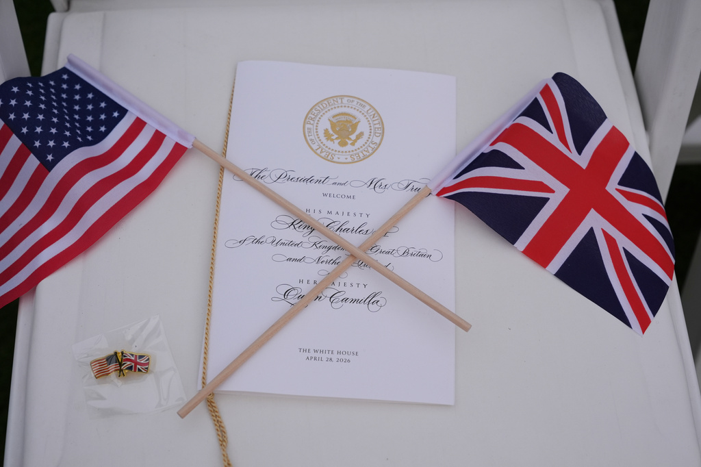 Programs and flags are seen on a chair on the South Lawn before President Donald Trump and first lady Melania Trump welcome Britain's King Charles III and Queen Camilla during a State Visit arrival ceremony at White House, Tuesday, April 28, 2026, in Washington. (AP Photo/Jacquelyn Martin)