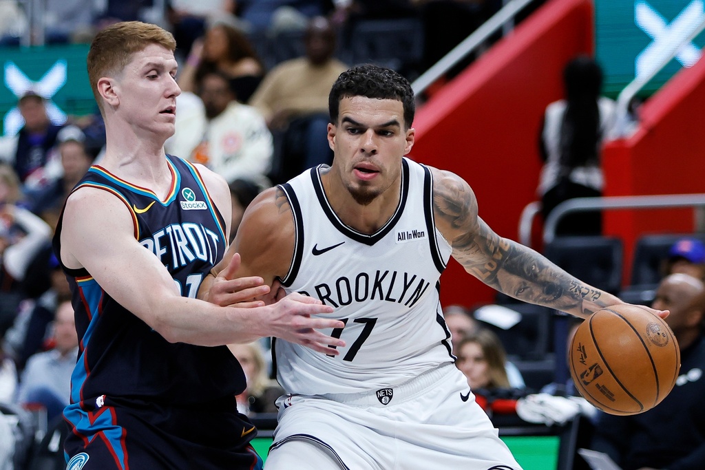 Brooklyn Nets forward Michael Porter Jr. (17) drives with the ball against Detroit Pistons guard Kevin Huerter, left, during the first half of an NBA basketball game Saturday, March 7, 2026, in Detroit. (AP Photo/Duane Burleson)