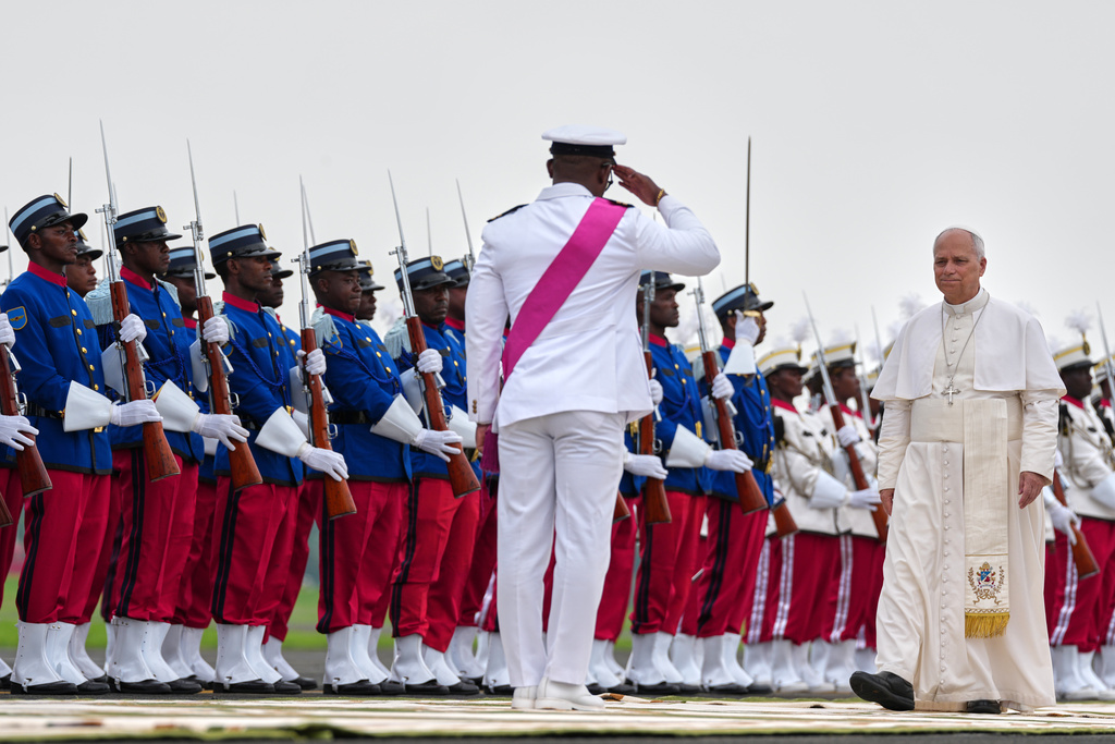 Pope Leo XIV, right, receives a guard of honour as he departs for Rome, marking the end of his visit to Africa in Malabo, Equatorial Guinea, Thursday, April 23, 2026. (AP Photo/Misper Apawu)