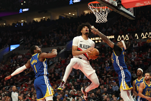 Portland Trail Blazers guard Shaedon Sharpe, center, drives to the basket between Golden State Warriors forward Jonathan Kuminga (1) and guard Gary Payton II (0) during the first half of an NBA basketball game Friday, Oct. 24, 2025, in Portland, Ore. (AP Photo/Amanda Loman) Portland Trail Blazers guard Shaedon Sharpe, center, drives to the basket between Golden State Warriors forward Jonathan Kuminga (1) and guard Gary Payton II (0) during the first half of an NBA basketball game Friday, Oct. 24, 2025, in Portland, Ore. (AP Photo/Amanda Loman)
