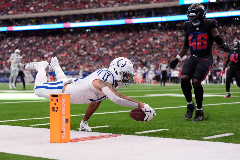 Indianapolis Colts wide receiver Michael Pittman Jr. (11) dives in an attempt to make a first down against the Houston Texans during the second half of an NFL football game in Houston, Sunday, Jan. 4, 2026. (AP Photo/Ashley Landis)