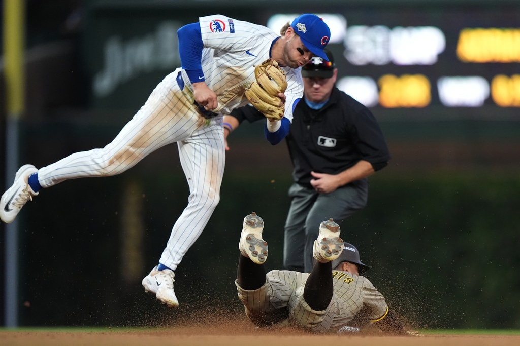 San Diego Padres' Xander Bogaerts steals second as Chicago Cubs' Nico Hoerner takes the throw during the seventh inning of Game 3 of a National League wild card baseball game Thursday, Oct. 2, 2025, in Chicago. (AP Photo/Nam Huh)