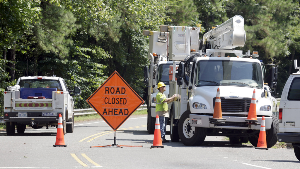 FILE - Utility crews work to restore lines that were knocked down on Estes Drive during tropical storm Chantal, Monday, July 7, 2025, in Chapel Hill, N.C. (AP Photo/Chris Seward, File)