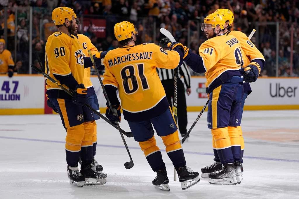 Nashville Predators teammates congratulate Nashville Predators center Steven Stamkos (91) after his goal during the second period of an NHL hockey game against the San Jose Sharks, Tuesday, March 24, 2026, in Nashville, Tenn. (AP Photo/George Walker IV)