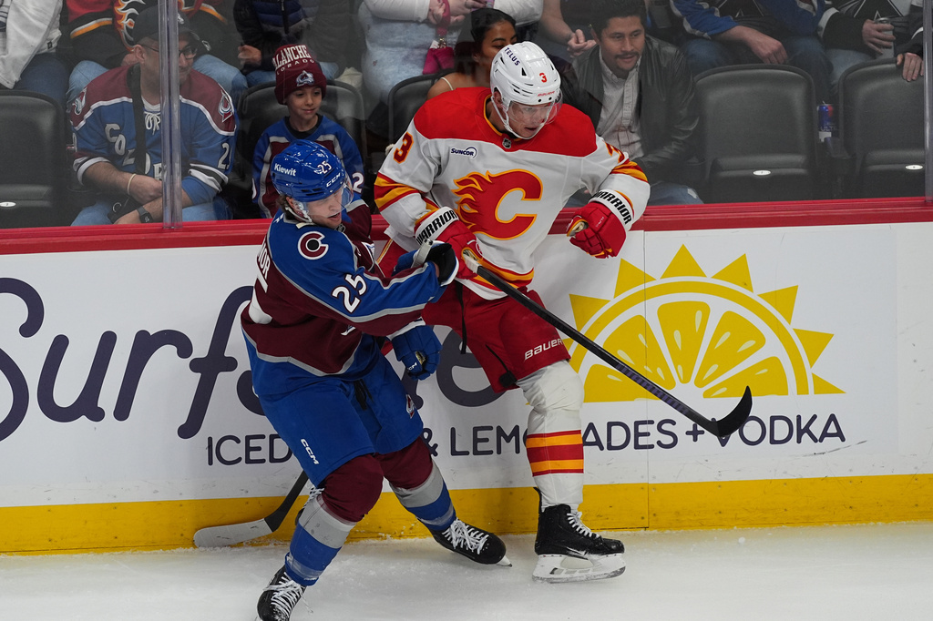 Colorado Avalanche right wing Logan O'Connor, left, checks Calgary Flames defenseman Olli Maatta, right, in the first period of an NHL hockey game Thursday, April 9, 2026, in Denver. (AP Photo/David Zalubowski)