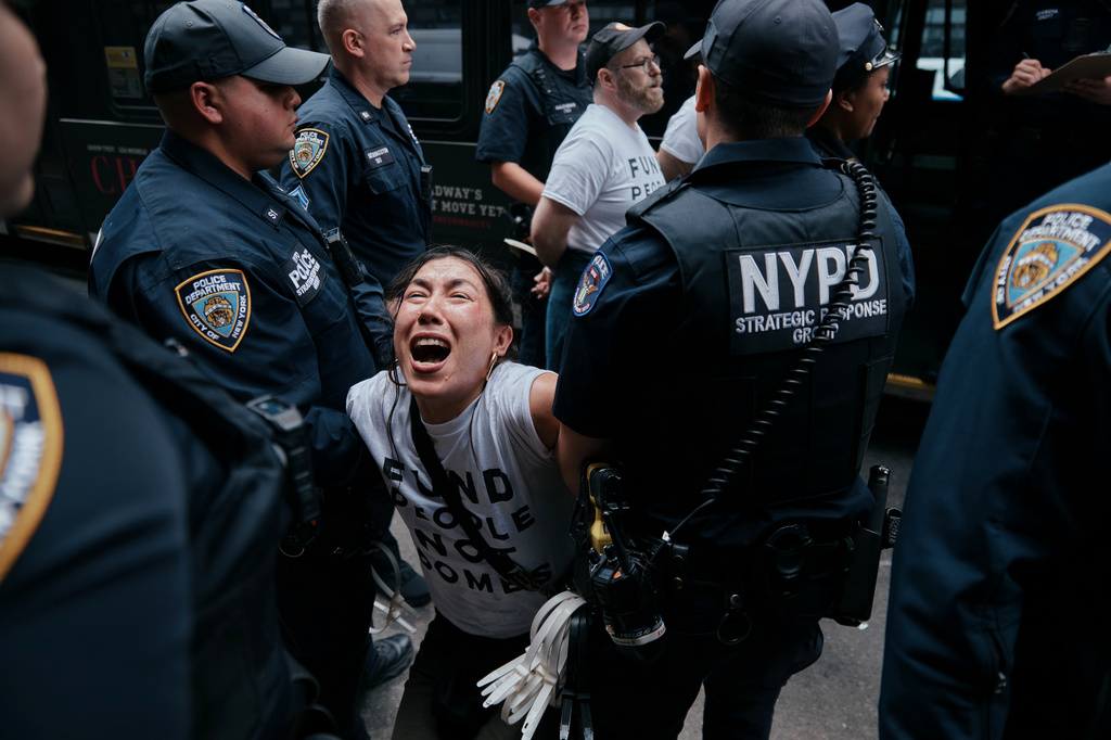 A protester with Jewish Voice for Peace gets arrested after blocking traffic during a demonstration outside the New York office of U.S. Sen. Chuck Schumer, calling for an end to the U.S.-Israel war with Iran and opposing U.S. weapons support, Monday, April 13, 2026, in New York. (AP Photo/Andres Kudacki)